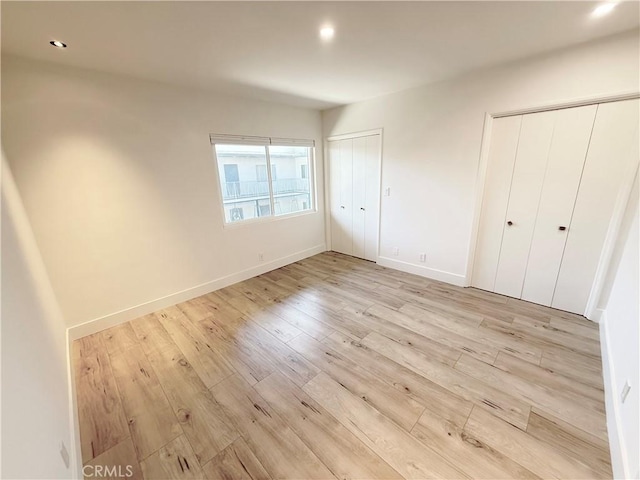 1126 N Central Ave Unit 303, Glendale, CA 91202 - unfurnished bedroom featuring multiple closets, light wood finished floors, and recessed lighting