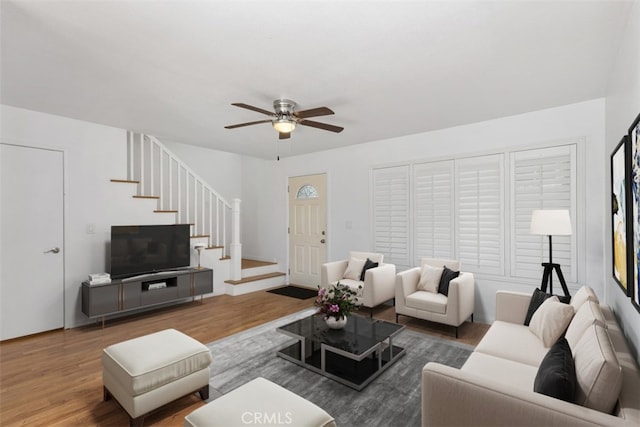 17695 Brittany Ln Unit 74, Huntington Beach, CA 92647 - living area with wood finished floors, a ceiling fan, and stairs