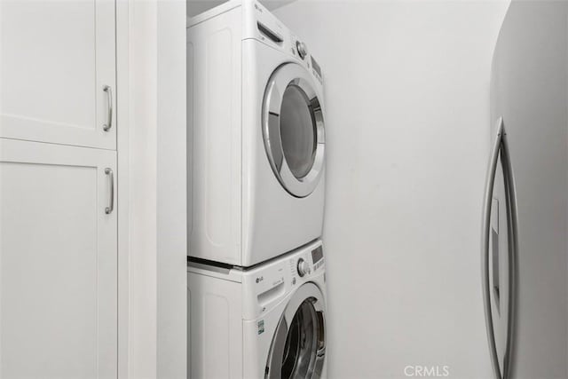 17695 Brittany Ln Unit 74, Huntington Beach, CA 92647 - laundry room with stacked washing machine and dryer and cabinet space