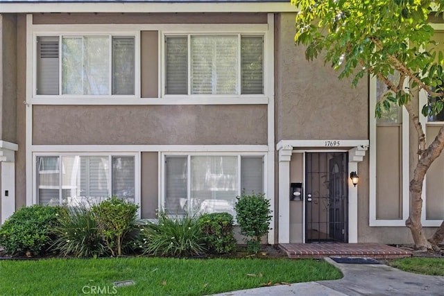 17695 Brittany Ln Unit 74, Huntington Beach, CA 92647 - doorway to property featuring stucco siding