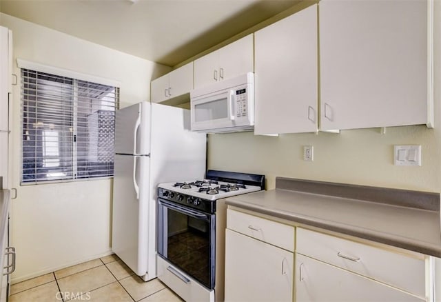 9920 Jordan Ave Unit 7, Chatsworth, CA 91311 - kitchen featuring white appliances, white cabinetry, and light tile patterned floors
