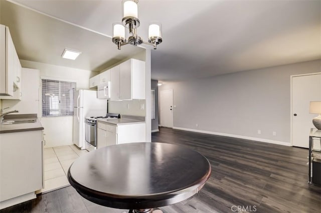 9920 Jordan Ave Unit 7, Chatsworth, CA 91311 - kitchen featuring stainless steel range with gas stovetop, white microwave, open floor plan, white cabinetry, and wood finished floors