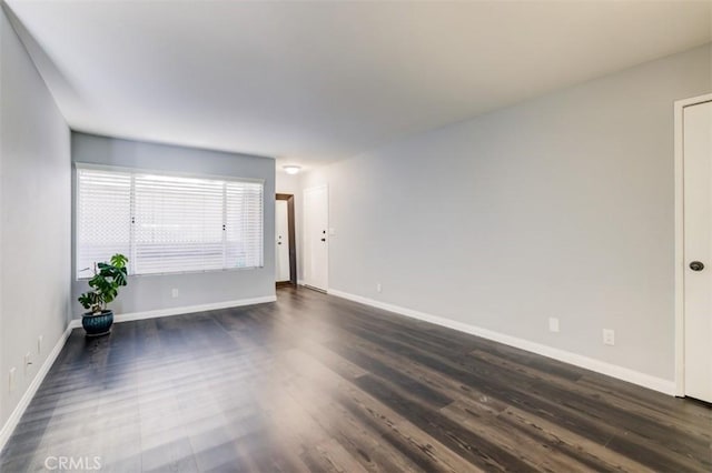 9920 Jordan Ave Unit 7, Chatsworth, CA 91311 - unfurnished living room with dark wood-style floors and baseboards