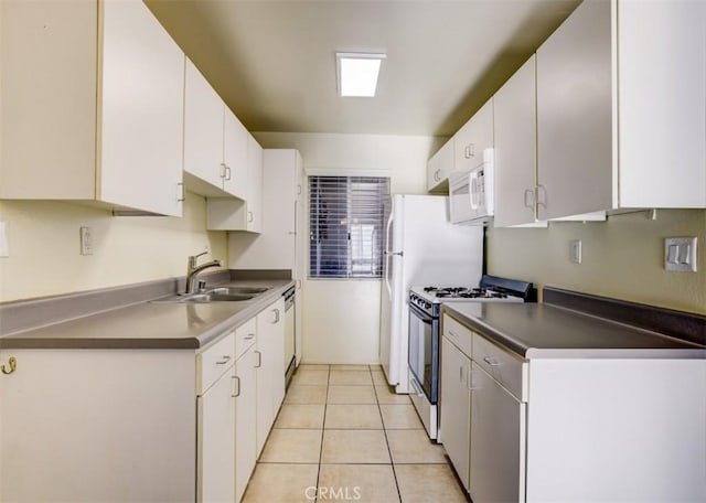 9920 Jordan Ave Unit 7, Chatsworth, CA 91311 - kitchen with appliances with stainless steel finishes, white cabinetry, light tile patterned floors, and dark countertops