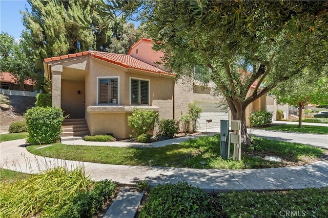 26337 Rainbow Glen Dr Unit 244, Newhall, CA 91321 - mediterranean / spanish house featuring stucco siding, a garage, a tile roof, and driveway
