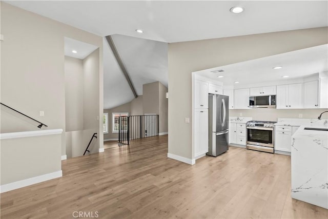 26337 Rainbow Glen Dr Unit 244, Newhall, CA 91321 - kitchen featuring stainless steel appliances, lofted ceiling, light wood-type flooring, recessed lighting, and white cabinetry