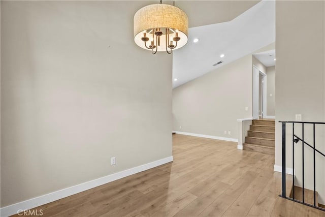 26337 Rainbow Glen Dr Unit 244, Newhall, CA 91321 - empty room with wood finished floors, recessed lighting, a chandelier, and stairway