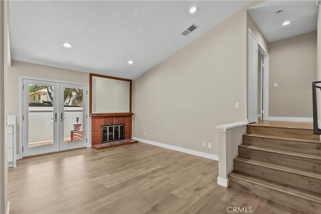 26337 Rainbow Glen Dr Unit 244, Newhall, CA 91321 - unfurnished living room with french doors, light wood-type flooring, stairs, recessed lighting, and lofted ceiling