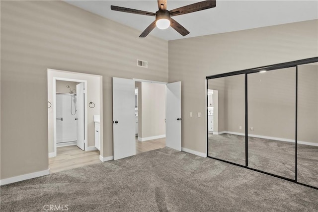 26337 Rainbow Glen Dr Unit 244, Newhall, CA 91321 - unfurnished bedroom with carpet, a closet, a towering ceiling, ensuite bathroom, and a ceiling fan