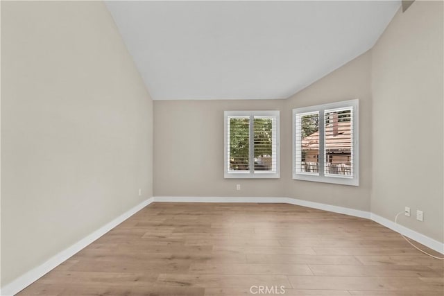 26337 Rainbow Glen Dr Unit 244, Newhall, CA 91321 - empty room with vaulted ceiling and light wood finished floors