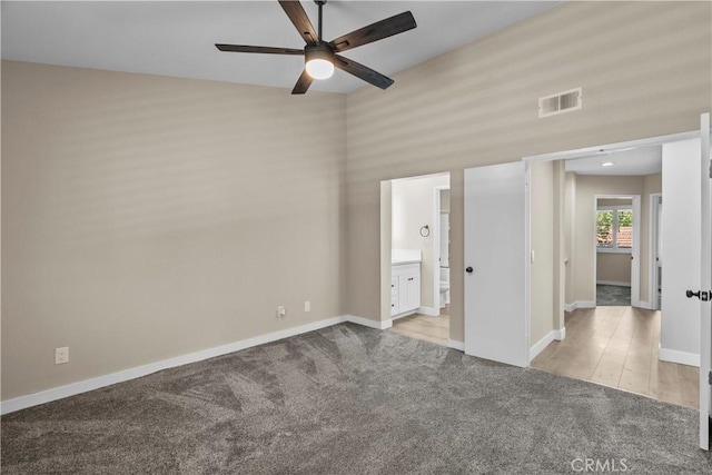 26337 Rainbow Glen Dr Unit 244, Newhall, CA 91321 - unfurnished bedroom featuring light colored carpet, connected bathroom, and a ceiling fan