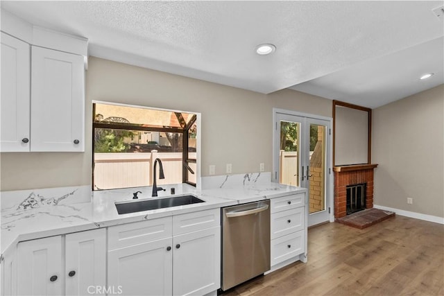 26337 Rainbow Glen Dr Unit 244, Newhall, CA 91321 - kitchen with dishwasher, white cabinets, light wood-style floors, light stone countertops, and a textured ceiling