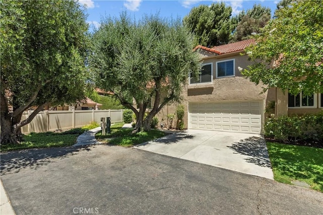 26337 Rainbow Glen Dr Unit 244, Newhall, CA 91321 - view of front of home featuring concrete driveway, stucco siding, a tile roof, and a garage