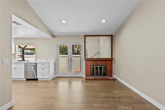 26337 Rainbow Glen Dr Unit 244, Newhall, CA 91321 - unfurnished living room featuring french doors, light wood-style flooring, recessed lighting, and a fireplace