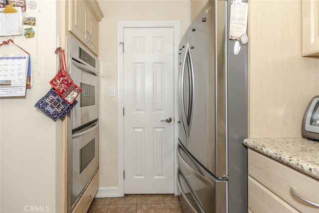 1118 N Central Ave Unit 14, Glendale, CA 91202 - kitchen featuring appliances with stainless steel finishes, tile patterned floors, and cream cabinets