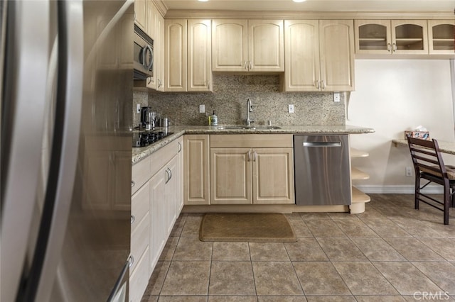 1118 N Central Ave Unit 14, Glendale, CA 91202 - kitchen with stainless steel appliances, backsplash, light stone counters, and glass insert cabinets