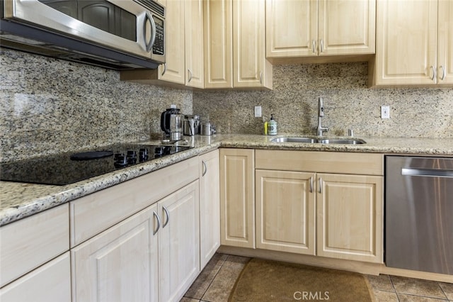 1118 N Central Ave Unit 14, Glendale, CA 91202 - kitchen with stainless steel appliances, backsplash, dark tile patterned flooring, light stone counters, and light brown cabinetry