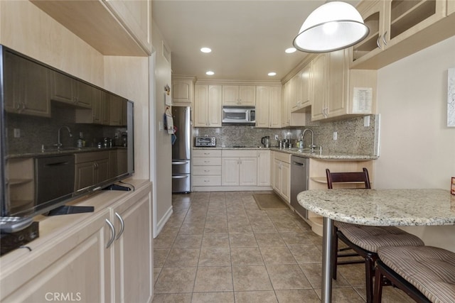 1118 N Central Ave Unit 14, Glendale, CA 91202 - kitchen with stainless steel appliances, backsplash, light stone countertops, recessed lighting, and hanging light fixtures
