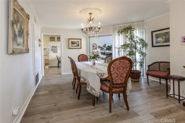 1118 N Central Ave Unit 14, Glendale, CA 91202 - dining space featuring a chandelier, crown molding, and wood finished floors
