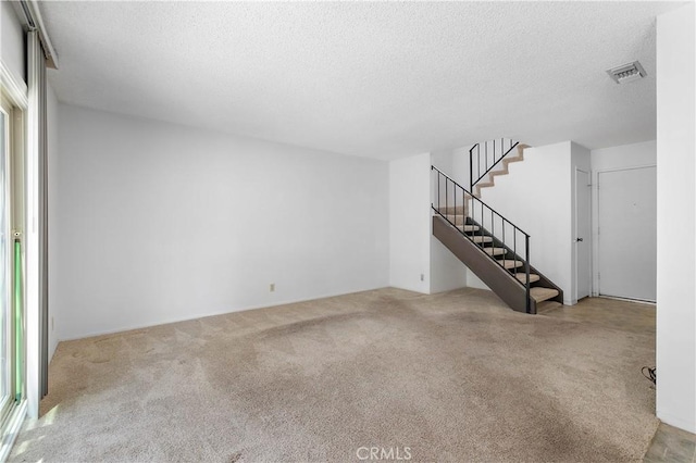 810 E Laurel Oak Dr, Azusa, CA 91702 - unfurnished living room with a textured ceiling, carpet floors, and stairs