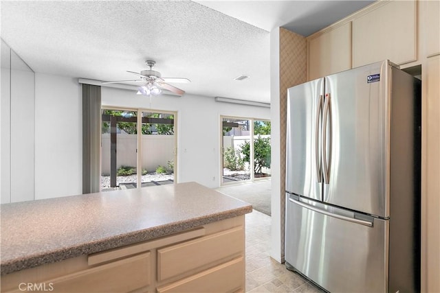 810 E Laurel Oak Dr, Azusa, CA 91702 - kitchen with freestanding refrigerator, plenty of natural light, a ceiling fan, cream cabinetry, and a textured ceiling