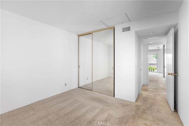 810 E Laurel Oak Dr, Azusa, CA 91702 - unfurnished bedroom with carpet flooring, a closet, and a textured ceiling