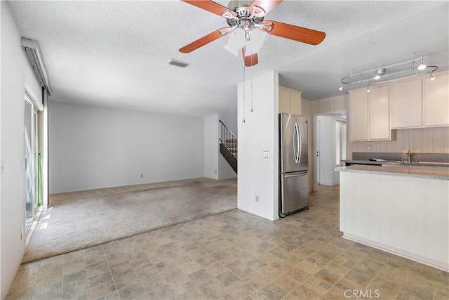 810 E Laurel Oak Dr, Azusa, CA 91702 - kitchen featuring freestanding refrigerator, open floor plan, a ceiling fan, a textured ceiling, and cream cabinets