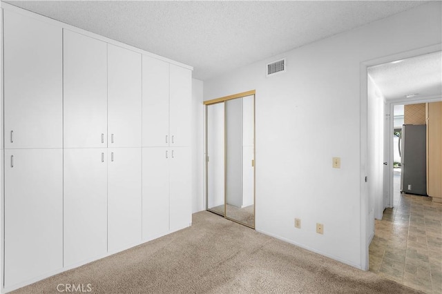 810 E Laurel Oak Dr, Azusa, CA 91702 - unfurnished bedroom with a textured ceiling, a closet, and light colored carpet