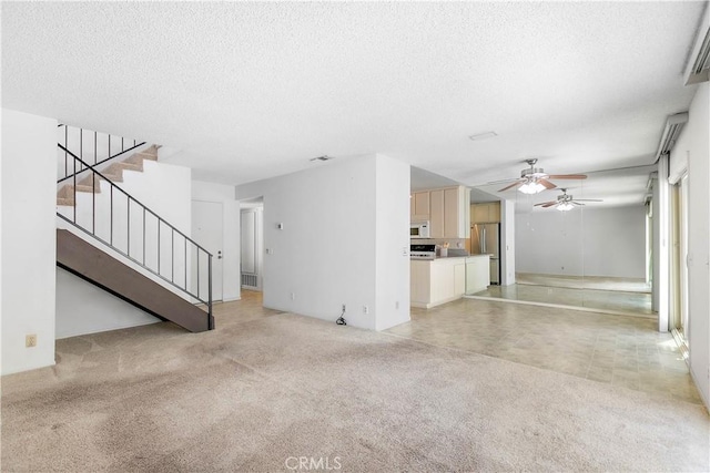 810 E Laurel Oak Dr, Azusa, CA 91702 - unfurnished living room featuring a textured ceiling, a ceiling fan, stairway, and light carpet