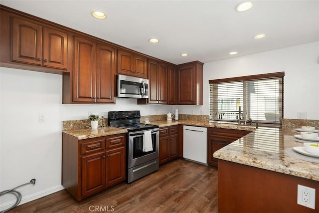 10 Starfall Unit 11, Irvine, CA 92603 - kitchen with appliances with stainless steel finishes, light stone counters, dark wood-style floors, and recessed lighting