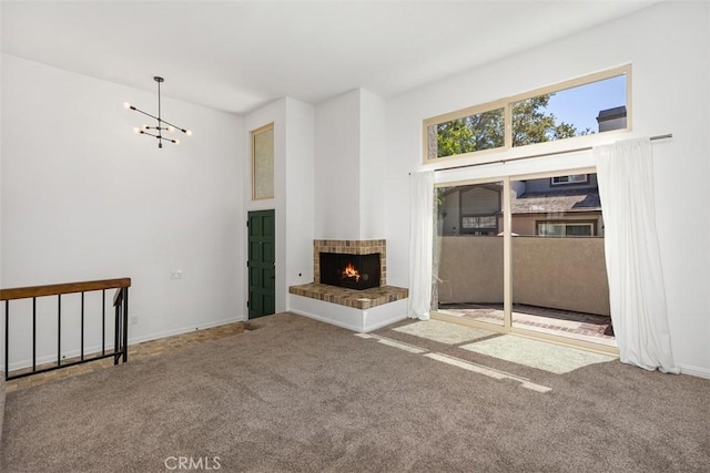 10 Starfall Unit 11, Irvine, CA 92603 - unfurnished living room with carpet floors, a chandelier, and a fireplace