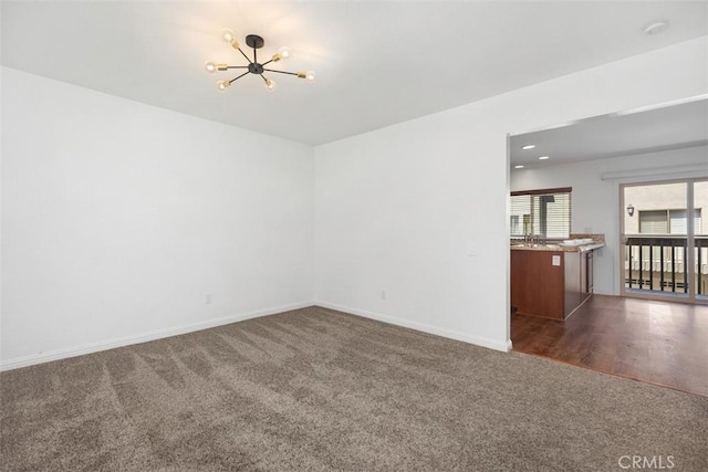 10 Starfall Unit 11, Irvine, CA 92603 - unfurnished room with dark colored carpet, a chandelier, and a smoke detector