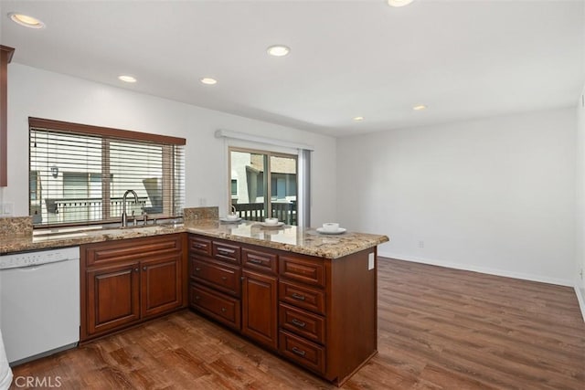 10 Starfall Unit 11, Irvine, CA 92603 - kitchen with dishwasher, dark wood-style flooring, light stone counters, recessed lighting, and a peninsula