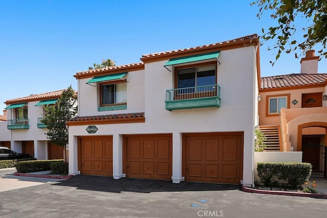 232 Villa Point Dr, Newport Beach, CA 92660 - mediterranean / spanish-style home with a tiled roof, an attached garage, and stucco siding