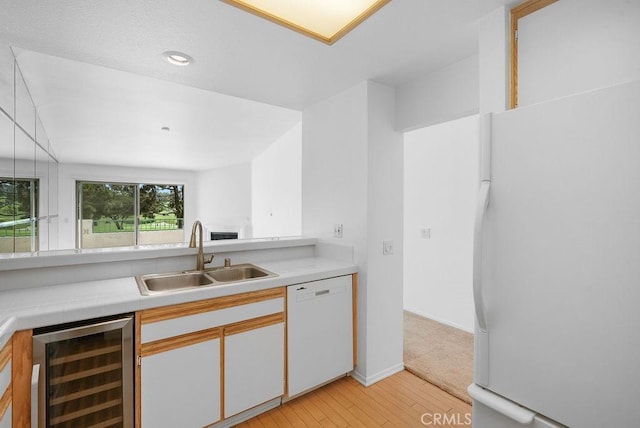 232 Villa Point Dr, Newport Beach, CA 92660 - kitchen with beverage cooler, white appliances, light wood-style flooring, and recessed lighting