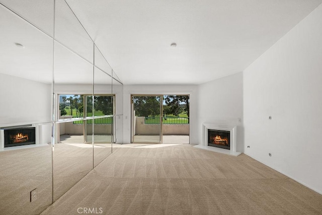 232 Villa Point Dr, Newport Beach, CA 92660 - unfurnished living room with a lit fireplace, carpet flooring, and healthy amount of natural light