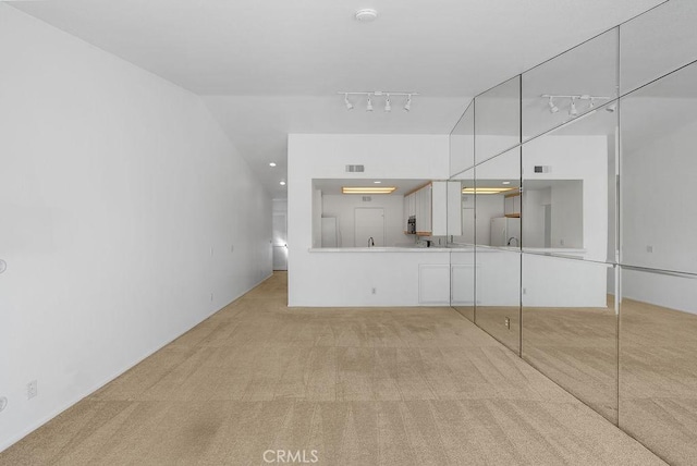 232 Villa Point Dr, Newport Beach, CA 92660 - unfurnished living room with light colored carpet and track lighting