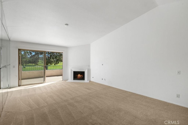 232 Villa Point Dr, Newport Beach, CA 92660 - unfurnished living room featuring carpet floors and a lit fireplace