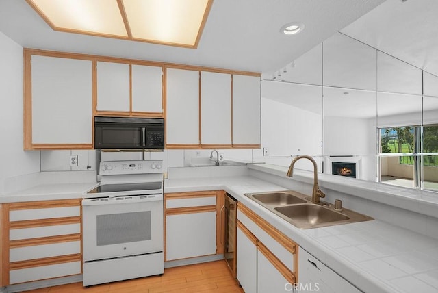 232 Villa Point Dr, Newport Beach, CA 92660 - kitchen with black microwave, electric range, light countertops, white cabinetry, and dishwasher