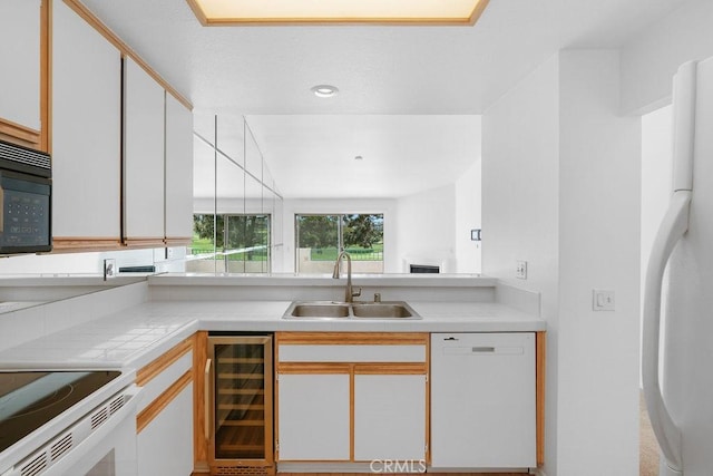 232 Villa Point Dr, Newport Beach, CA 92660 - kitchen with wine cooler, white appliances, light countertops, and white cabinetry