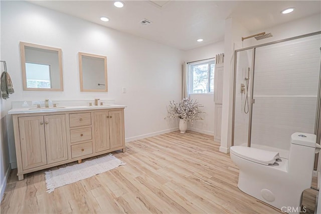 35356 Sierra Vista Dr, Agua Dulce, CA 91390 - bathroom with wood finished floors, a shower stall, double vanity, and recessed lighting