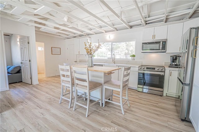 35356 Sierra Vista Dr, Agua Dulce, CA 91390 - kitchen with stainless steel appliances, light wood-style flooring, and white cabinets