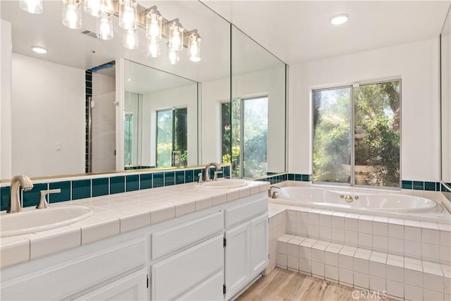 35356 Sierra Vista Dr, Agua Dulce, CA 91390 - bathroom featuring double vanity, a bath, wood finished floors, and recessed lighting