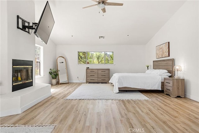 35356 Sierra Vista Dr, Agua Dulce, CA 91390 - bedroom featuring wood finished floors, a glass covered fireplace, and high vaulted ceiling