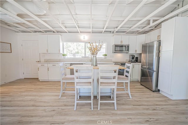 35356 Sierra Vista Dr, Agua Dulce, CA 91390 - kitchen featuring appliances with stainless steel finishes, light wood-style floors, white cabinetry, and light countertops