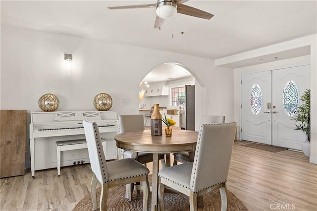 35356 Sierra Vista Dr, Agua Dulce, CA 91390 - dining space with ceiling fan, arched walkways, and light wood-type flooring
