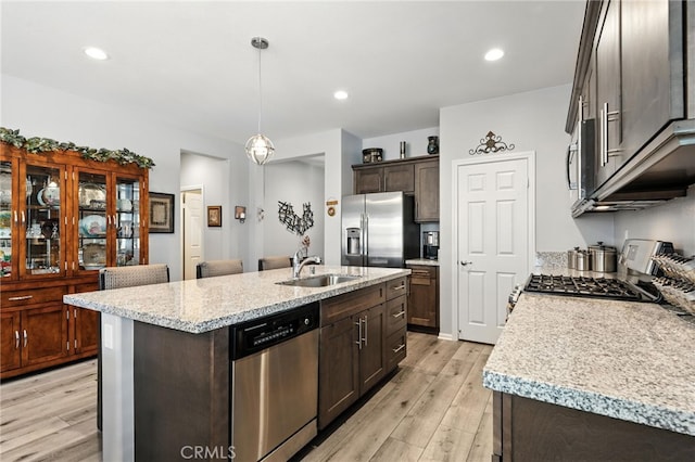 1616 Rosemary, Beaumont, CA 92223 - kitchen featuring appliances with stainless steel finishes, light wood-type flooring, dark brown cabinets, a center island with sink, and recessed lighting