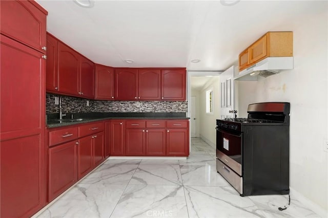 6681 Rostrata Ave, Buena Park, CA 90621 - kitchen featuring stainless steel gas range oven, reddish brown cabinets, under cabinet range hood, light marble finish floors, and dark countertops