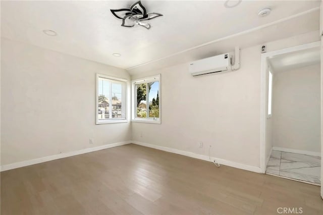 6681 Rostrata Ave, Buena Park, CA 90621 - unfurnished room featuring an AC wall unit, a smoke detector, wood finished floors, and ceiling fan