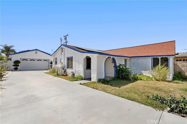 6681 Rostrata Ave, Buena Park, CA 90621 - view of front of property featuring stucco siding, driveway, solar panels, and a garage
